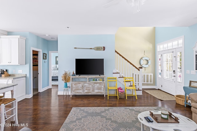 living room with dark hardwood / wood-style floors and ceiling fan