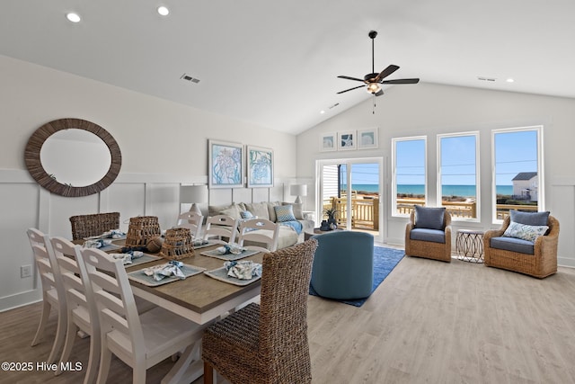 dining area with visible vents, a ceiling fan, wood finished floors, a decorative wall, and recessed lighting