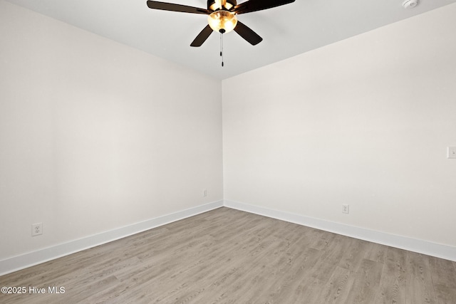 unfurnished room featuring ceiling fan, wood finished floors, and baseboards