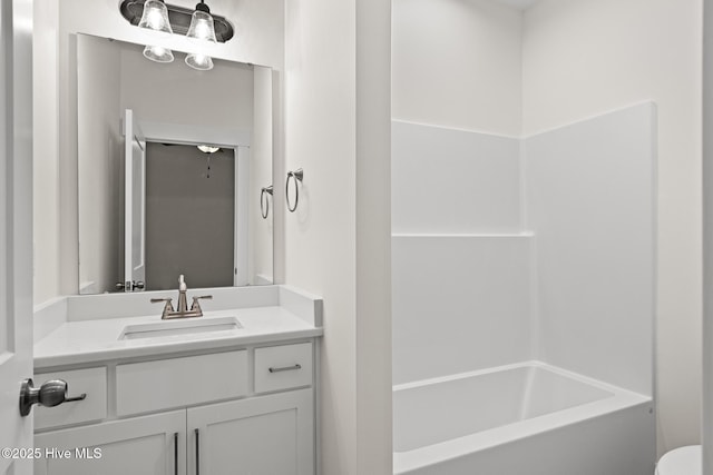 bathroom featuring toilet, vanity, and shower / tub combination