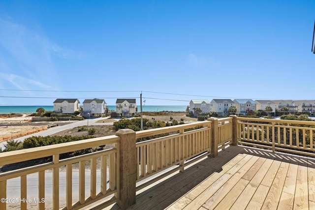 wooden deck featuring a water view and a residential view