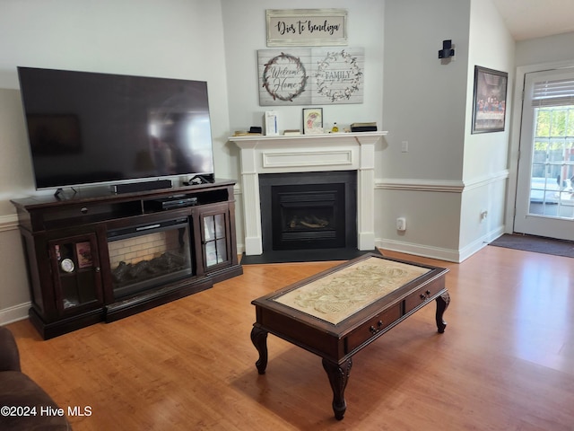 living room featuring hardwood / wood-style flooring and vaulted ceiling