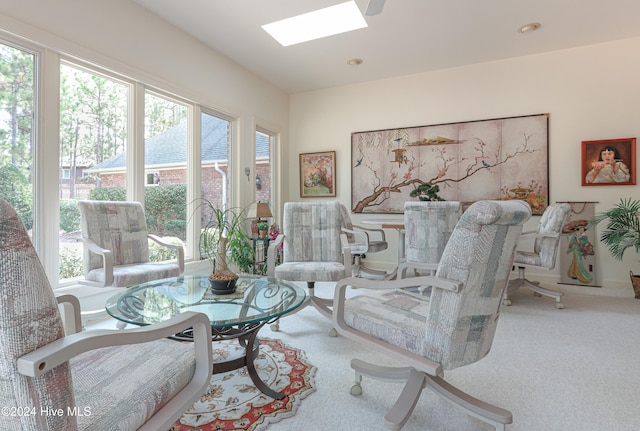 living room featuring carpet and a skylight