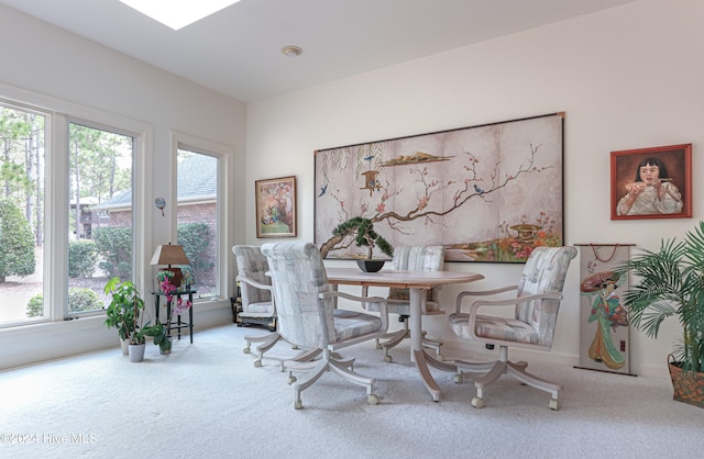 dining room with carpet flooring and a healthy amount of sunlight