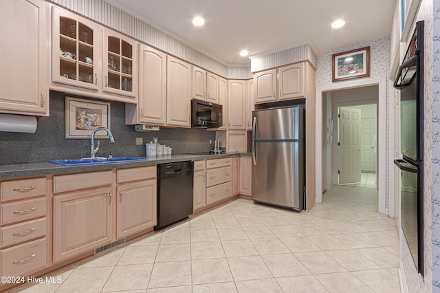 kitchen with light brown cabinets, black appliances, crown molding, sink, and light tile patterned floors