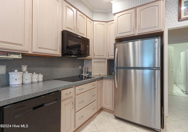 kitchen with light tile patterned floors, light brown cabinets, washer / clothes dryer, and black appliances