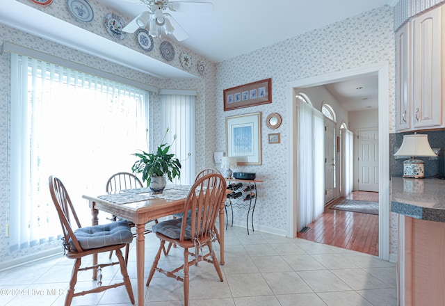 dining space with ceiling fan and light wood-type flooring