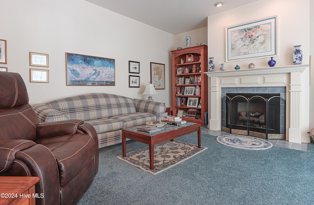 carpeted living room with a tile fireplace