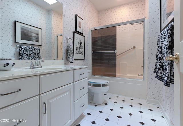 full bathroom featuring shower / bath combination with glass door, vanity, and toilet