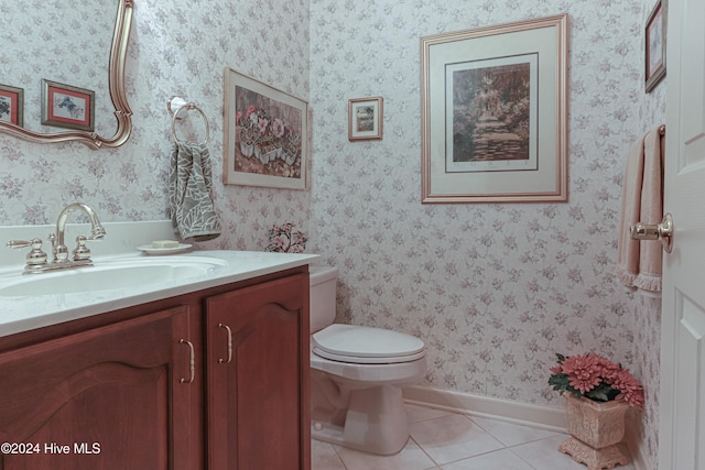 bathroom featuring tile patterned flooring, vanity, and toilet