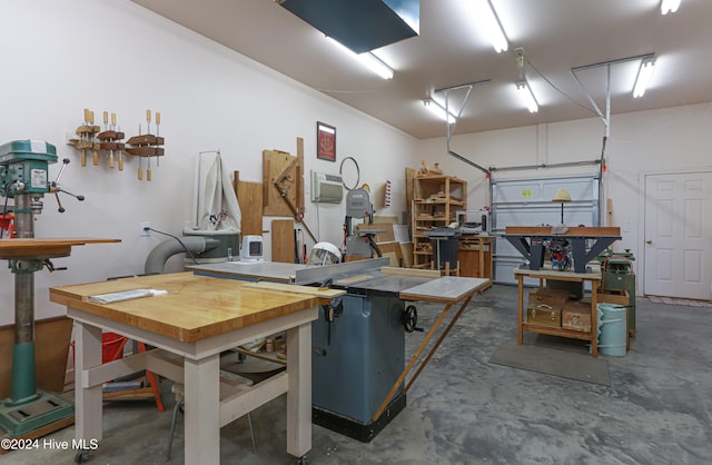 garage with a workshop area and a wall unit AC