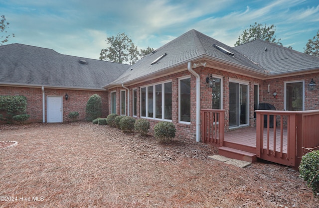 rear view of property featuring a deck