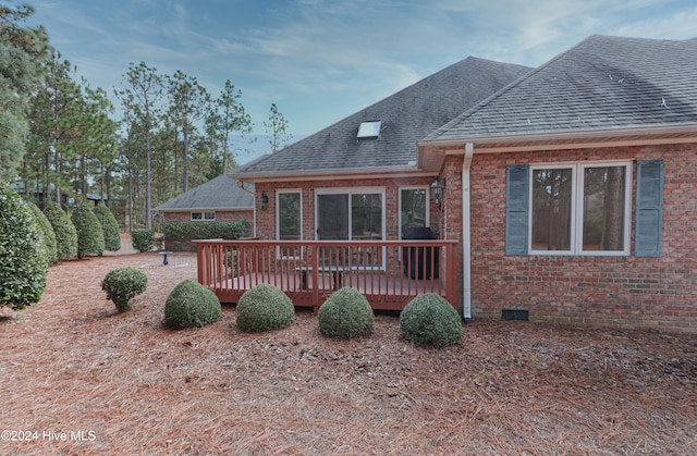 back of house featuring a deck