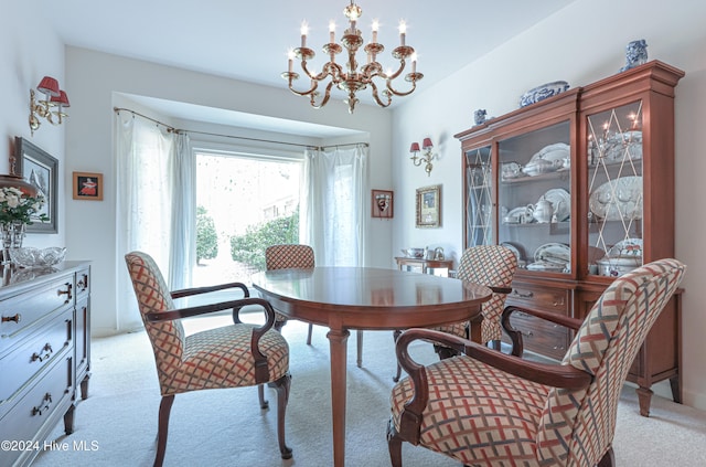 carpeted dining room with a chandelier