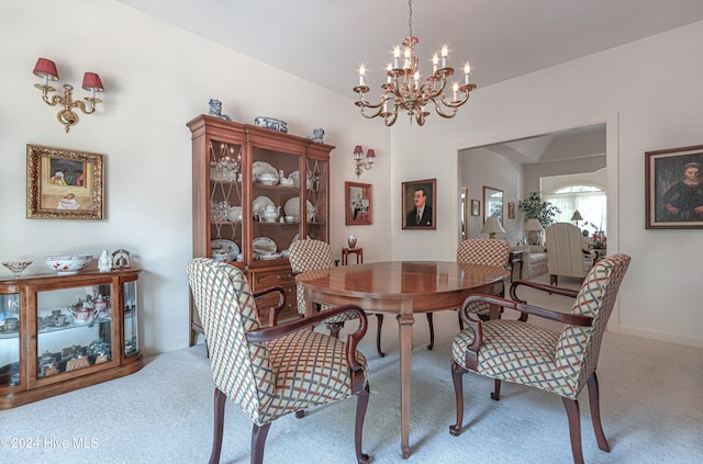 carpeted dining space featuring an inviting chandelier