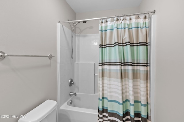 bathroom with shower / bath combo with shower curtain and toilet