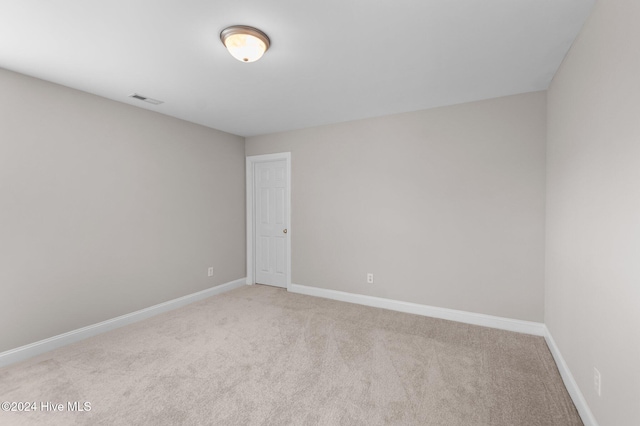 unfurnished room with light carpet