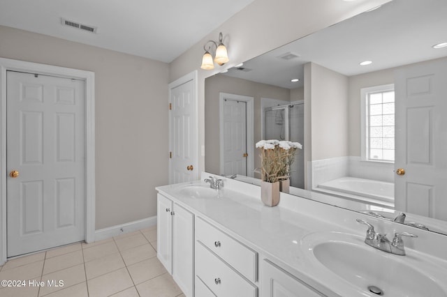 bathroom featuring shower with separate bathtub, vanity, and tile patterned floors