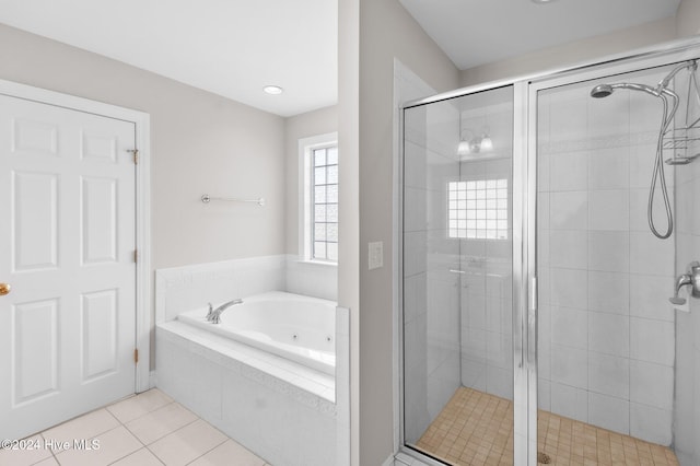 bathroom featuring tile patterned floors and shower with separate bathtub