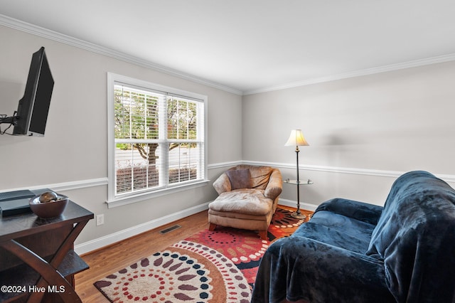 sitting room featuring hardwood / wood-style flooring and crown molding