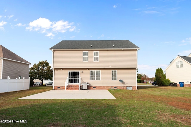 back of house with a patio and a lawn