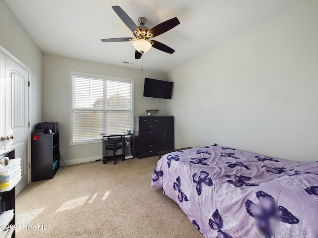 bedroom featuring light carpet and ceiling fan