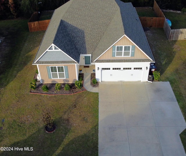 view of front of property with a garage and a front lawn