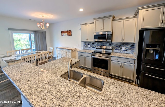 kitchen featuring appliances with stainless steel finishes, gray cabinetry, dark wood-type flooring, and sink