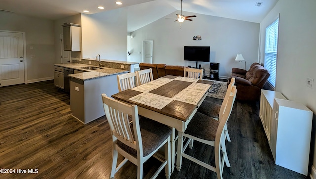 dining space featuring lofted ceiling, ceiling fan, dark wood-type flooring, and sink