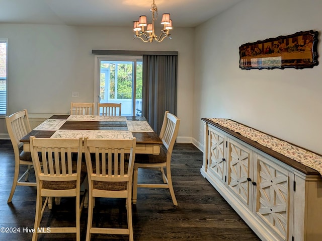 dining space with dark wood-type flooring and a notable chandelier