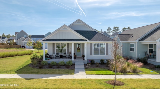 view of front of home with covered porch and a front lawn