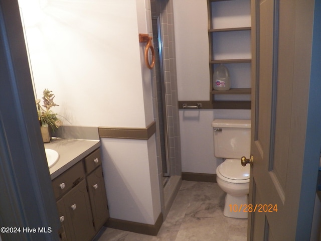 bathroom with a shower, vanity, and toilet