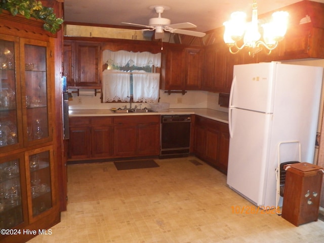 kitchen featuring white refrigerator, black dishwasher, pendant lighting, sink, and ceiling fan with notable chandelier