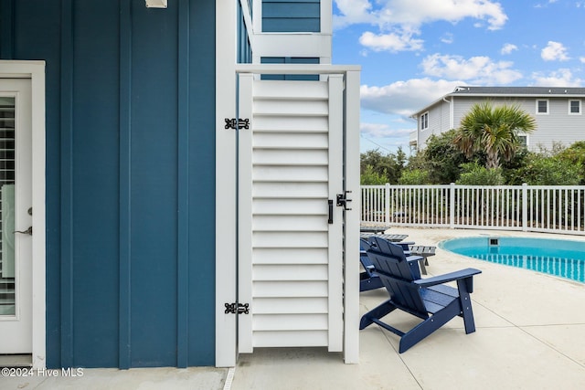 view of patio with a fenced in pool