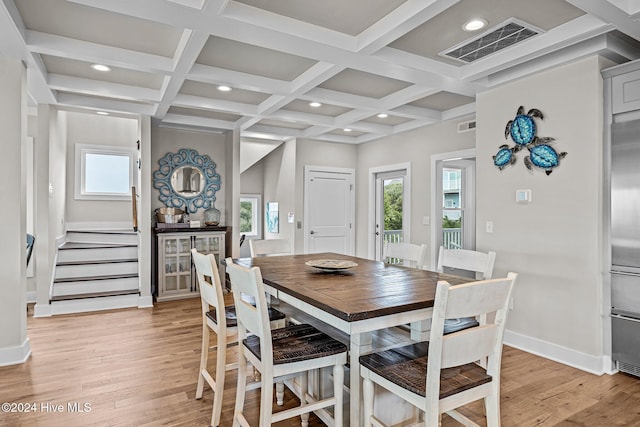 dining room featuring beam ceiling, light hardwood / wood-style flooring, and coffered ceiling