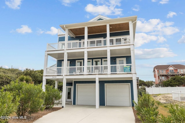 coastal inspired home featuring a garage and a balcony