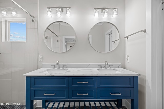 bathroom with vanity and tiled shower