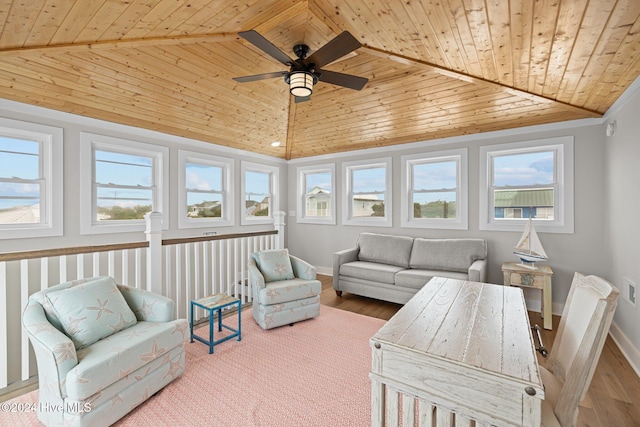 sunroom featuring lofted ceiling, wooden ceiling, and ceiling fan