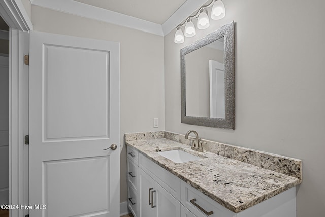 bathroom featuring vanity and ornamental molding