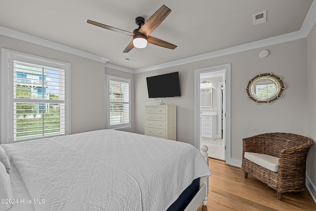 bedroom with ceiling fan, crown molding, light hardwood / wood-style floors, and ensuite bathroom