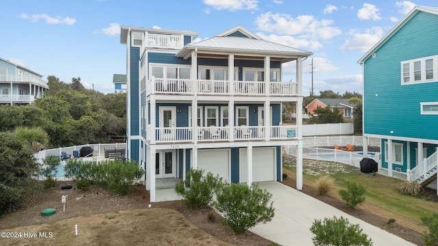 rear view of property with a balcony and a garage