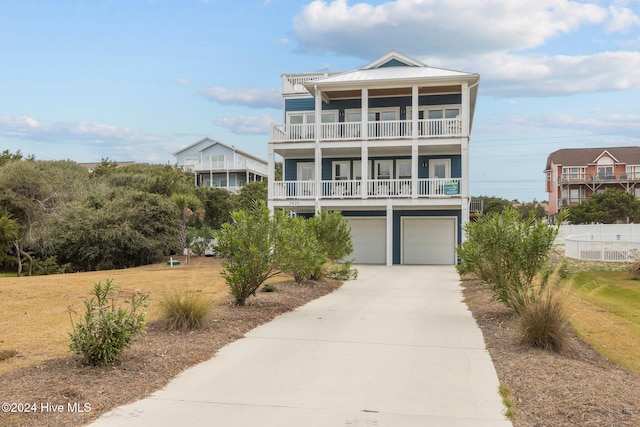 coastal inspired home with a garage and a balcony