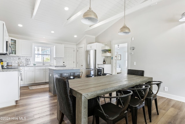 dining room with lofted ceiling, crown molding, wood ceiling, and wood-type flooring