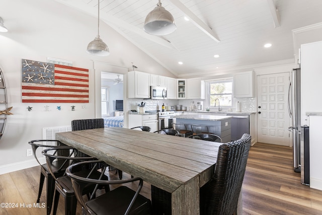 dining room with wooden ceiling, beamed ceiling, sink, dark hardwood / wood-style floors, and high vaulted ceiling