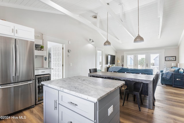 kitchen with white cabinetry, stainless steel refrigerator, dark hardwood / wood-style floors, pendant lighting, and beverage cooler