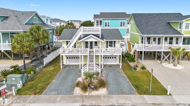 coastal home with a garage, a carport, and a porch