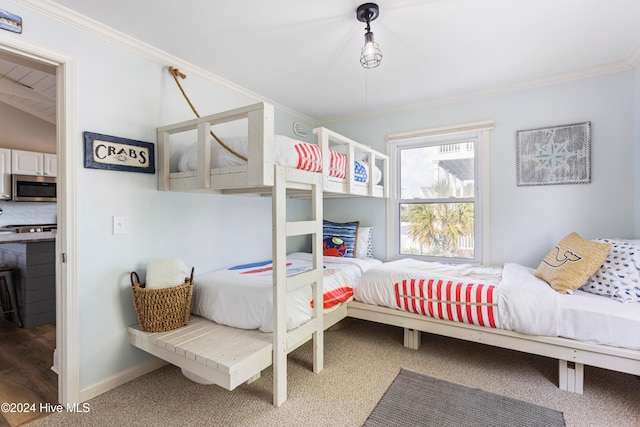 bedroom with lofted ceiling, carpet floors, and ornamental molding