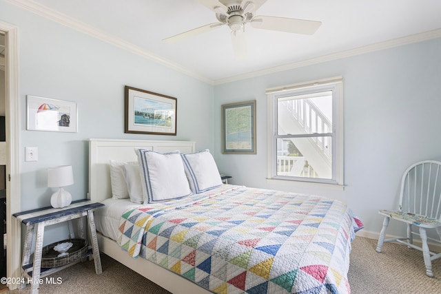 carpeted bedroom featuring ceiling fan and ornamental molding