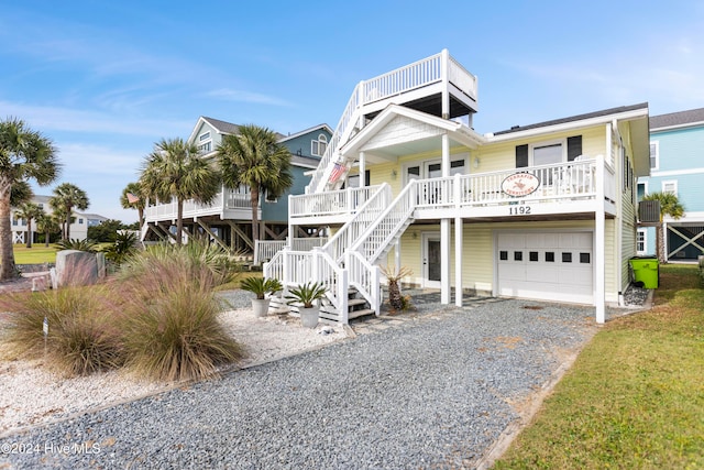 beach home with a garage and covered porch