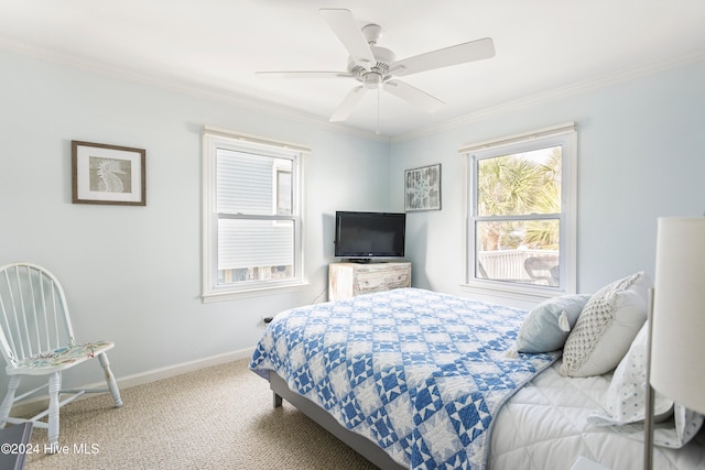 carpeted bedroom featuring ceiling fan and ornamental molding